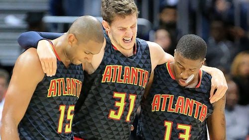 Hawks’ Al Horford (left) and Lamar Patterson (right) help Mike Muscala off the court after he was injured against the Pistrons during the second half in their first regular season basketball game on Tuesday, Oct. 27, 2015 in Atlanta. The Pistons beat the Hawks 106-94. Curtis Compton / ccompton@ajc.com