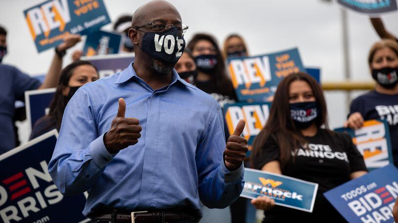 US senate candidate Rev. Raphael Warnock meets campaign volunteers at the Get Out The Early Vote with Jon Ossoff, Rev. Raphael Warnock, Carolyn Bourdeaux, and the Biden Campaign at Shorty Howell Park in Duluth, Georgia, on Saturday, October 24, 2020. (Rebecca Wright for the Atlanta Journal-Constitution) 