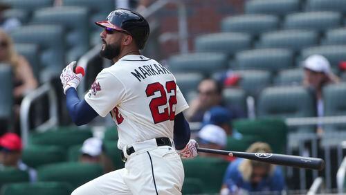 Atlanta Braves right fielder Nick Markakis (22) follows through on a two-run double int he second inning of a baseball game against the Cincinnati Reds, Sunday, Aug. 20, 2017, in Atlanta. (AP Photo/John Bazemore)