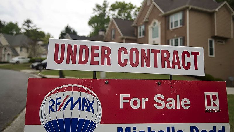 A home for sale sign is displayed in the yard of a home in Powder Springs, Tuesday, April 7, 2020. AJC File 