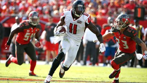 Atlanta Falcons wide receiver Julio Jones (11) slips between Tampa Bay Buccaneers outside linebacker Lavonte David (54) and strong safety Chris Conte (23) during the second quarter of an NFL football game Sunday, Dec. 6, 2015, in Tampa, Fla. (AP Photo/Brian Blanco)