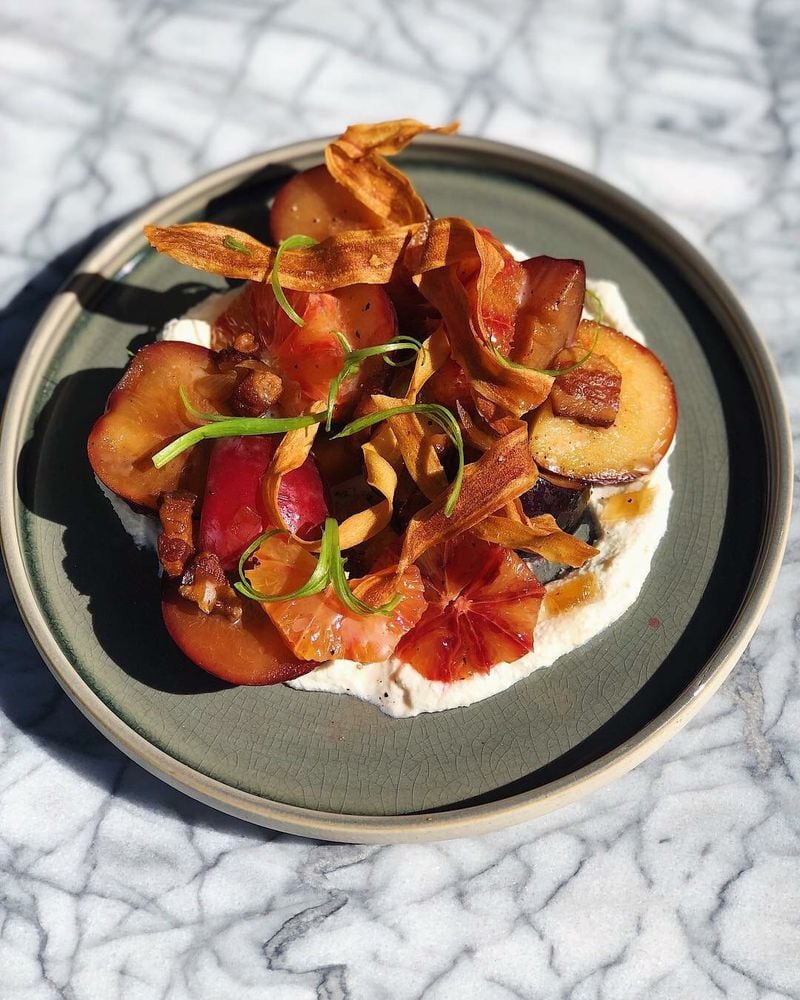Restaurant Holmes encourages small plates for sharing, like grilled plum and ricotta with bacon vinaigrette.