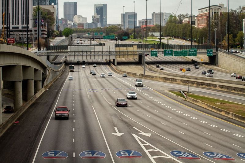With coronavirus concerns, not a lot of people were hitting the road on the nice day. Cars head northbound at the  I-85, I-75 split in Atlanta on Sunday morning March 22, 2020. (Photo: STEVE SCHAEFER / SPECIAL TO THE AJC)