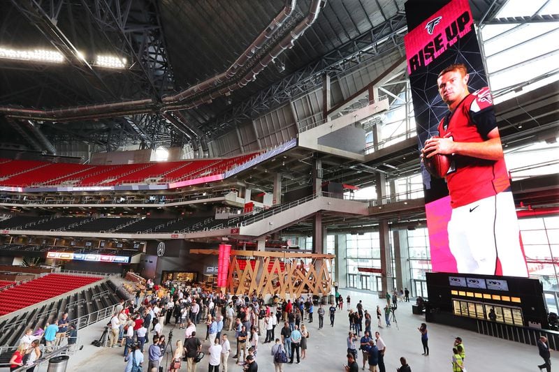 NFL MVP Matt Ryan flashes on a 101-foot tall digital screen in the front porch area of Mercedes-Benz Stadium during an open house tour of the facility. The Falcons will host Arizona Saturday in the official opening of the $1.5 billion stadium in downtown Atlanta.
