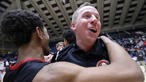 Greater Atlanta Christian head coach David Eaton celebrates beating Jenkins, 67-53, to win the Class AAA boys basketball championship game on  March 8, 2018, in Macon. Eaton’s Spartans are No. 1 again, riding an 11-game winning steak with recent victories over No. 10 Shiloh of Class AAAAAAA and Independence of Charlotte, the defending champion in North Carolina’s Class AAAA.