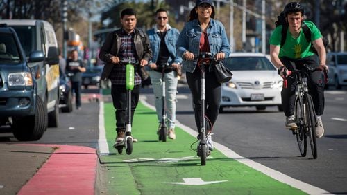 People ride LimeBike, left, and Bird electric scooters on the Embarcadero in San Francisco on April 13, 2018. MUST CREDIT: David Paul Morris/Bloomberg Photo by: David Paul Morris - Bloomberg