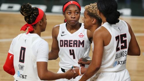 Dream players Odyssey Sims (from left), Aari McDonald , Courtney Williams, and Monique Billings huddle up against the Chicago Sky on Wednesday, May 19, 2021, in College Park.     “Curtis Compton / Curtis.Compton@ajc.com”