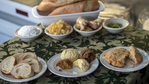 Savannah's Unforgettable Bakery and Café, which is owned by Haitian native Belinda Baptiste, creates items such as vegan Bon Bon Sirop and a gluten-free Bon Bon Amidon, shown together (center, front row), along with Komparét (right, front row) and a Haitian baguette (left, front row). (Stephen B. Morton for The Atlanta Journal-Constitution)