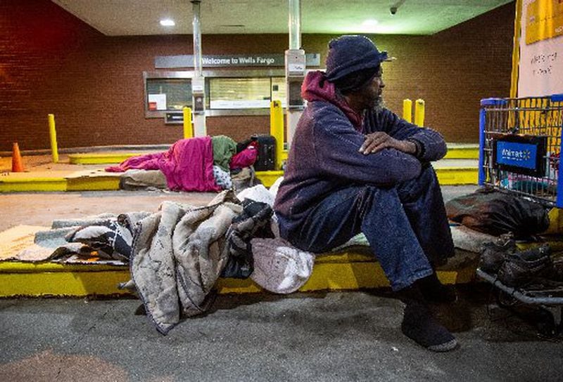 Micheal Russ gets up after spending the night under the drive-thru of a West End bank Wednesday, November 27, 2019. STEVE SCHAEFER / SPECIAL TO THE AJC