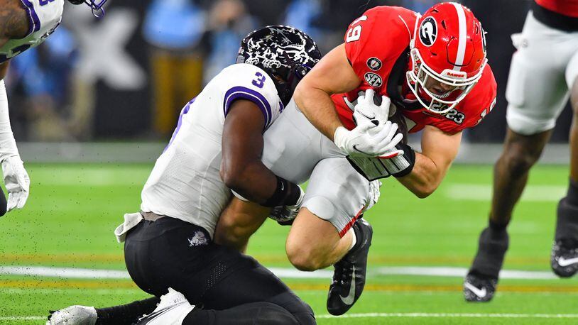Georgia tight end Brock Bowers runs for a first down against TCU safety Mark Perry (3) during the first half of the College Football Playoff National Championship at SoFi Stadium in Los Angeles on Monday, Jan. 9, 2023. (Hyosub Shin / Hyosub.Shin@ajc.com)