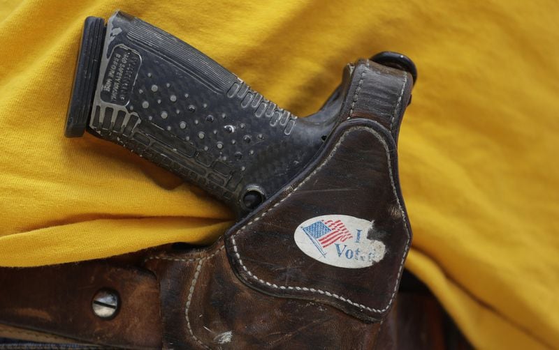In this April 14, 2018 file photo, a man wears an unloaded pistol during a pro gun-rights rally in Austin, Texas. In a letter sent to the Senate on Thursday, Sept. 12, 2019, (AP Photo/Eric Gay, File)