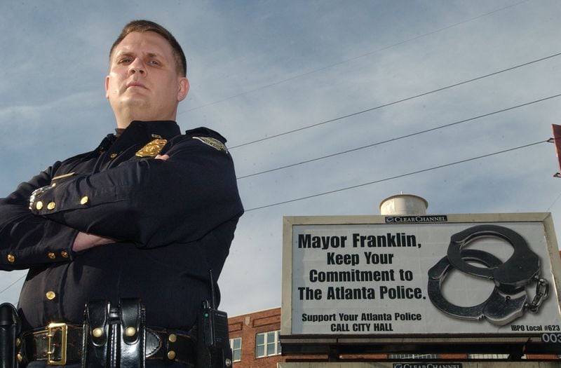 In February 2004, then-Sgt. Scott Kreher of the Atlanta Police Department stood in front of a billboard complaining about police pay.  