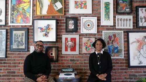 George and Esohe Galbreath pose for a photo in front of their art collection at their home.The couple began collecting art more than ten years ago and now have over 200 pieces in their collection. (Natrice Miller/ Natrice.miller@ajc.com)
