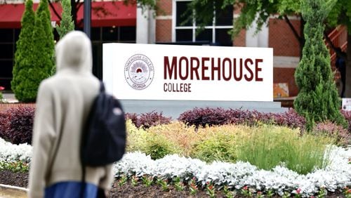 A student walks by a Morehouse College sign in Atlanta on April 24. (Miguel Martinez/The Atlanta Journal-Constitution)