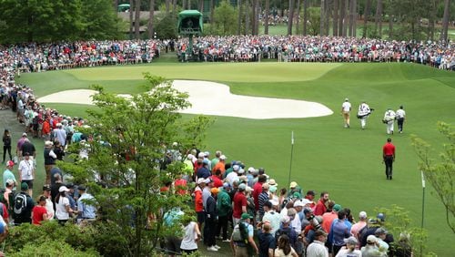 Last year's Masters champion, Tiger Woods, walks to the 6th green during the final round Sunday, April 14, 2019, at Augusta National Golf Club in Augusta.