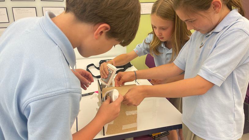 With glue, tape and dexterity, The Lovett School students assemble a prototype birdhouse as part of a design and engineering class.