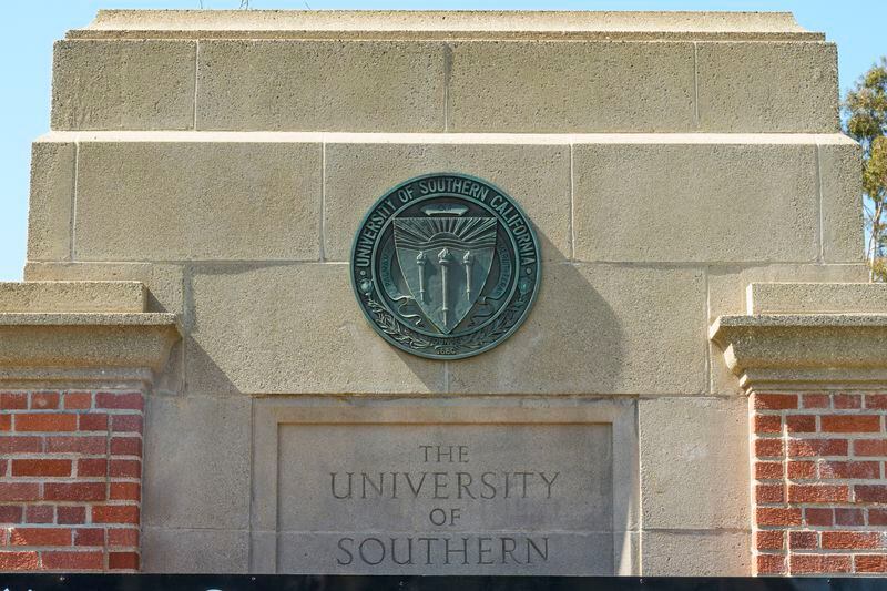 The emblem for the University of Southern California is mounted at a campus entrance in Los Angeles Tuesday, April 16, 2024. University of Southern California officials have canceled a commencement speech by its 2024 valedictorian, a pro-Palestinian Muslim, citing "substantial risks relating to security and disruption" of the event that draws 65,000 people to campus. (AP Photo/Damian Dovarganes)