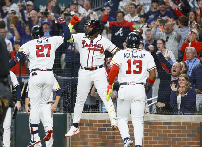 Atlanta Braves third baseman Austin Riley (27) celebrates after a two-run home run against the Philadelphia Phillies during the eighth inning of NLDS Game 2 in Atlanta on Monday, Oct. 9, 2023.   (Miguel Martinez / Miguel.Martinezjimenez@ajc.com)