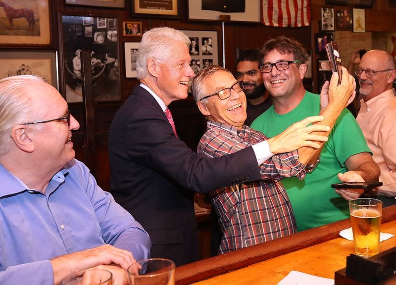 Patrons at the bar snap a selfie and enjoy a laugh with former president Bill Clinton as he works the crowd at historic Manuel's Tavern on Wednesday, August 24, 2016, in Atlanta. Curtis Compton /ccompton@ajc.com