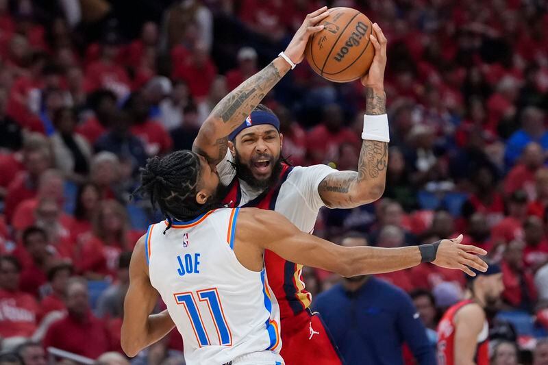 New Orleans Pelicans forward Brandon Ingram is fouled by Oklahoma City Thunder guard Isaiah Joe (11) as he drives to the basket in the first half of Game 3 of an NBA basketball first-round playoff series in New Orleans, Saturday, April 27, 2024. (AP Photo/Gerald Herbert)