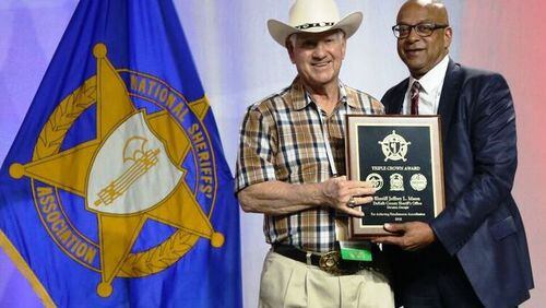 DeKalb County Sheriff Jeffrey Mann, right, accepts a second consecutive Triple Crown Award from National Sheriffs’ Association President Sheriff Harold Eavenson at the NSA Conference in New Orleans.