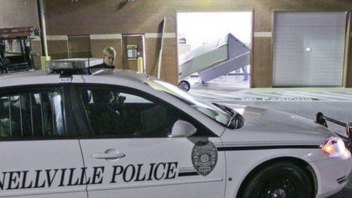 Snellville police converse at a crime scene on March 12, 2012.