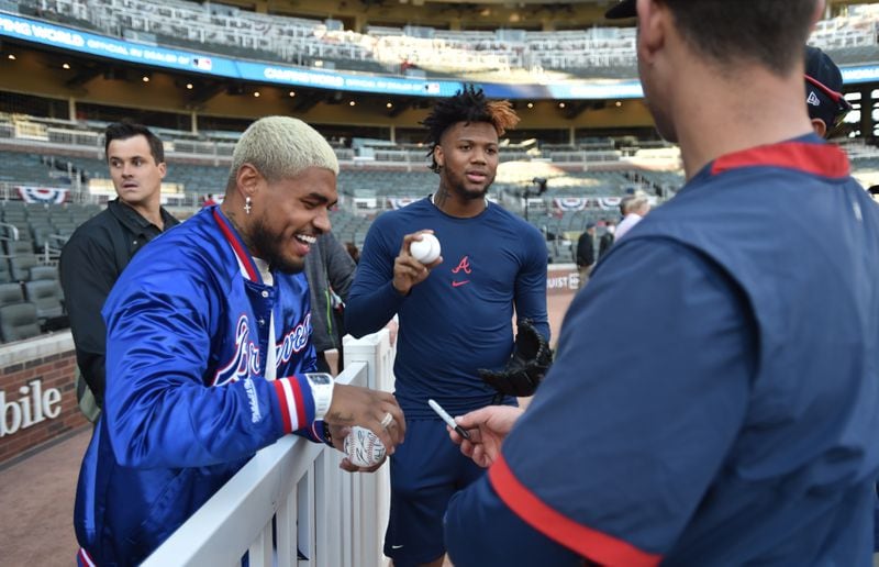 Atlanta United striker Josef Martinez (left) smiles as he talks with Braves outfielder Ronald Acuna before Game 2 of the NLCS against the Los Angeles Dodgers Sunday, Oct. 17, 2021, at Truist Park in Atlanta. Both Martinez and Acuna - who is recovering from a knee injury suffered in the regular season - hail from Venezuela. (Hyosub Shin / Hyosub.Shin@ajc.com)