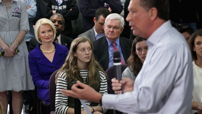 Republican presidential candidate Ohio Gov. John Kasich addresses an audience, including former speaker of the House Newt Gingrich and his wife Callista Gingrich, during a town hall-style meeting in Virginia last March. Chip Somodevilla/Getty Images