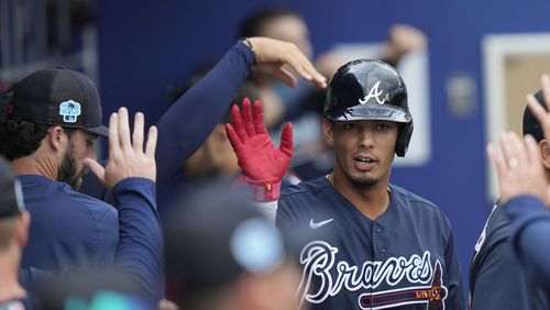 Atlanta Braves designated hitter Vaughn Grissom is greeted in the dugout after scoring on an RBI single by Orlando Arcia in the fourth inning of a spring training baseball game against the Philadelphia Phillies in North Port, Fla., Saturday, March 18, 2023. (AP Photo/Gerald Herbert)