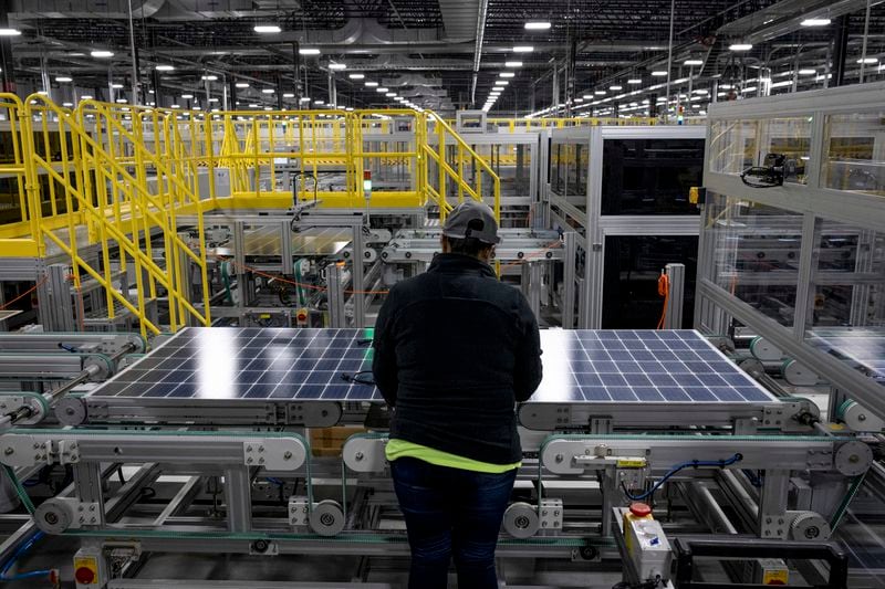 A worker inspects a solar panel at the Qcells solar panel factory in Dalton in November. (Christian Monterrosa/The New York Times)
                      