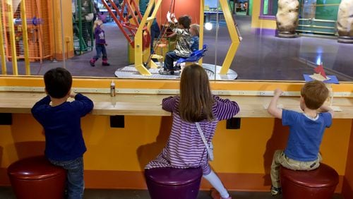 Kids build a project from wood sticks at the The Children's Museum of Atlanta.