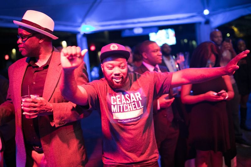 Supporters dance during an election party for Atlanta mayoral candidate Ceasar Mitchell at Park Tavern.
