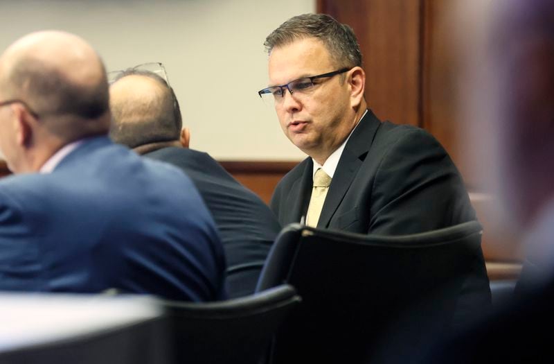 Court of Appeals Judge Christian Coomer talks to his legal team at Cobb County Superior Court on day one of his trial for alleged ethic violations on Monday, October 17, 2022. (Natrice Miller/natrice.miller@ajc.com)  


