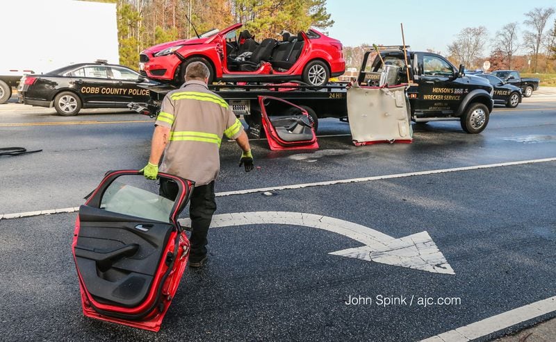Cobb County fire crews that responded to the accident had to cut off the top of the car to free the driver. JOHN SPINK / JSPINK@AJC.COM
