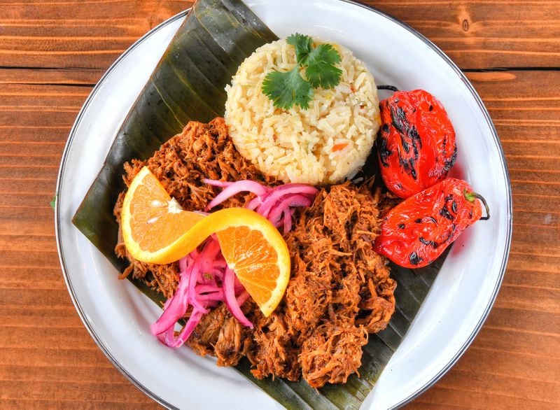 Antiguo Lobo's Cochinita plate: slow-roasted pork, axiote sour orange Yucatan marinade, rice, cebolla morada. (Chris Hunt for The Atlanta Journal-Constitution)