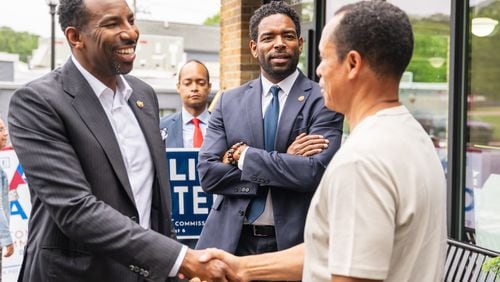 Fulton County Commissioner Candidate Ali Carter and Atlanta Mayor Andre Dickens meet supporters during local campaigning on Thursday, May 9, 2024, in the Cascade Heights neighborhood of Atlanta. (Atlanta Journal-Constitution/Jason Allen)