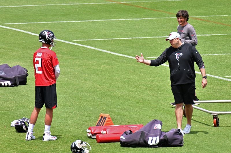 Falcons head coach Arthur Smith confers with  quarterback Matt Ryan (2) during a mandatory minicamp Wednesday, June 9, 2021, in Flowery Branch. (Hyosub Shin / Hyosub.Shin@ajc.com)