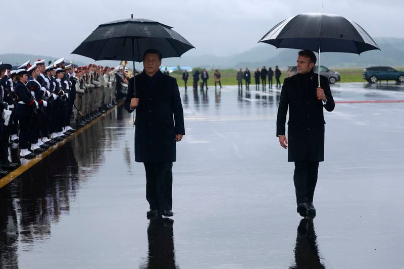 Chinese President Xi Jinping, left, and French President Emmanuel Macron review the troops before Xi Jinping's departure, Tuesday, May 7, 2024 at the Tarbes airport, southwestern France. French President Emmanuel Macron made a point of inviting Chinese President Xi Jinping to the Tourmalet Pass near the Spanish border, where Macron spent time as a child visiting his grandmother. (AP Photo/Aurelien Morissard, Pool)
