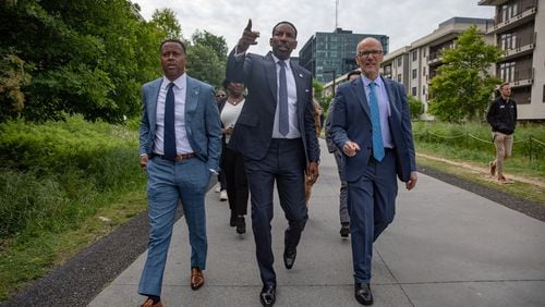 From left: BeltLine, Inc. CEO and President Clyde Higgs, Atlanta Mayor Andre Dickens and White House Senior Advisor Tom Perez stroll down the eastside trail of the Beltline on April 24, 2024 ahead of an announcement that a majority of the trail loop will be completed ahead of the 2026 FIFA World Cup. Riley Bunch/AJC