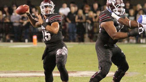 Mississippi State offensive lineman Justin Malone (70) and Elgton Jenkins (74) block for quarterback Dak Prescott (15) as he prepares to pass during the first half of an NCAA college football game against Kentucky in Starkville, Miss., Saturday, Oct. 24, 2015. (AP Photo/Jim Lytle)
