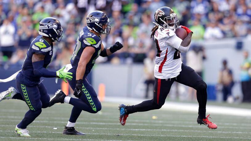 Atlanta Falcons running back Cordarrelle Patterson runs with the ball as Seattle Seahawks safety Quandre Diggs (6) and linebacker Cody Barton (57) chase in an NFL football game, Sunday, Sept. 25, 2022, in Seattle. (AP Photo/ John Froschauer)