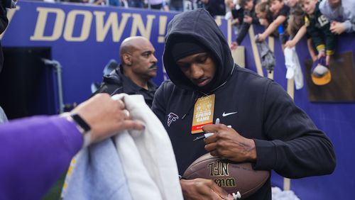 Atlanta Falcons quarterback Michael Penix Jr. signs autographs for fans during Washington's spring football game Friday, May 3, 2024, in Seattle. (AP Photo/Lindsey Wasson)