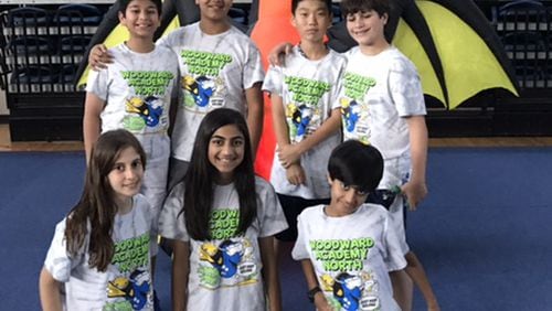 Woodward Academy North’s Odd-a-bot Division 2 Odyssey of the Mind team: (Kneeling, left to right) Alyssa Khahil, Mischa Patel, and Sachin Patel; and (standing, left to right) Rajveer Singh, Namit Miglani, Anderson Park, and Ryan Seeb.