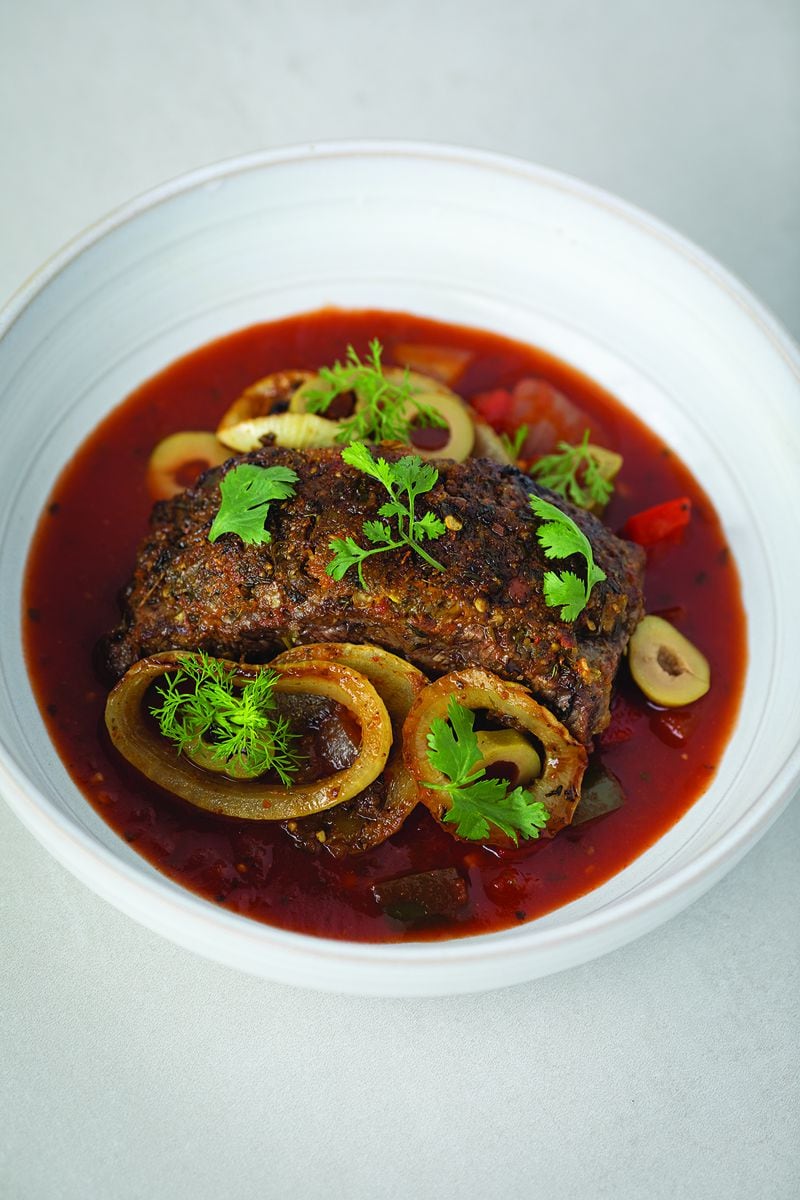 Beef that’s seared then braised is at the core of this rich, savory and saucy Puerto Rican bistec encebollado. From "Roots, Heart, Soul: The Story, Celebration, and Recipes of Afro Cuisine in America" by Todd Richards with Amy Paige Condon. (Courtesy of Harvest)