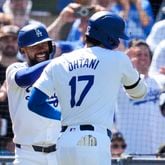 Los Angeles Dodgers designated hitter Shohei Ohtani celebrates with Teoscar Hernández, left, after hitting a home run during the eighth inning of a baseball game against the Atlanta Braves in Los Angeles, Sunday, May 5, 2024. (AP Photo/Ashley Landis)