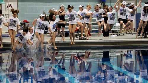 The Georgia women's swim team jumps in a pool after winning the NCAA women's swimming and diving championships in Minneapolis, Saturday, March 22, 2014. (AP Photo/Andy Clayton-King)