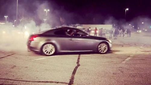 More than 100 people were arrested early Sunday after gathering in a Sam's Club parking lot to watch street racing, according to police. (Clayton County Police Department)