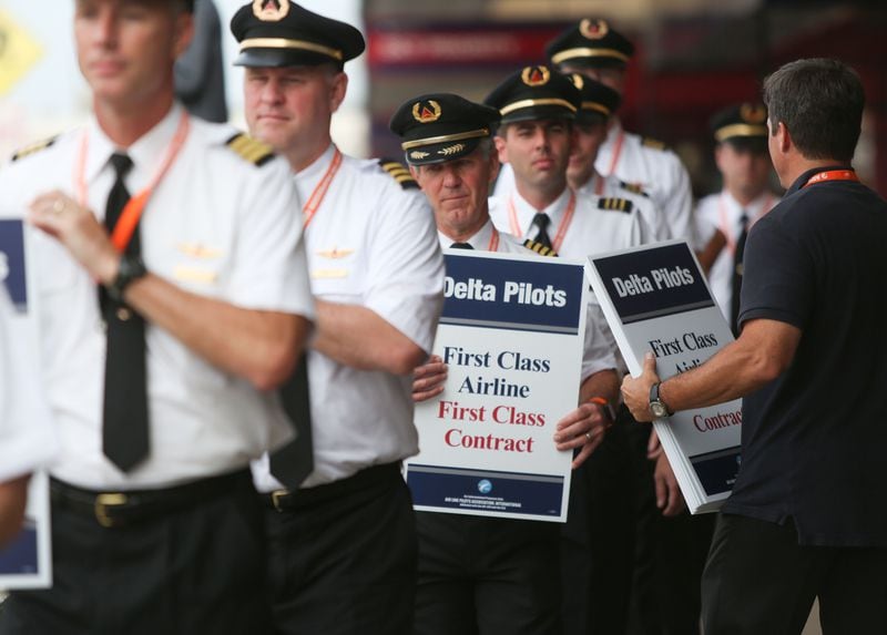 June 24, 2016 Atlanta: Delta pilots conduct informational picketing at the south terminal at Hartsfield-Jackson Atlanta International Airport on Friday morning. Delta pilots are raising awareness and urgency with Delta management for higher pay in negotiations for a new labor contract. "We are almost six months overdue for a new labor contract," said Master Executive Council (MEC) Chairman of Delta Airlines, John Malone, who has worked at Delta Airlines for 28 years. Delta pilots around the country also participated on Friday morning. EMILY JENKINS/ EJENKINS@AJC.COM
