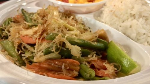Casual, no-frills Decatur restaurant Janet’s Kitchen has a small menu of traditional Filipino entrees. Pictured is vegetable pancit, a dish of rice noodles with cabbage, baby corn, snow peas and other veggies, a serving of white rice and a side order of mango salad. LIGAYA FIGUERAS / LFIGUERAS@AJC.COM