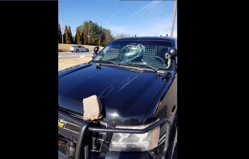 A man threw a brick into the windshield of a Gwinnett County Sheriff's Office patrol car.
